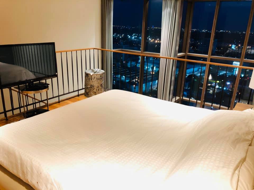 Spacious 1-bed, 2-bath duplex condo at The Emporio Place, 83 sqm, high floor with river view. Prime Sukhumvit 24 location near BTS Phrom Phong. Rent: 55,000 THB/month.